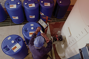 worker filling blue container