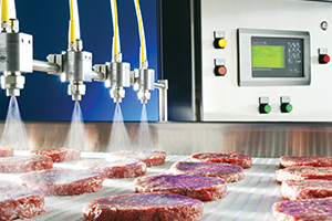 pulsajet nozzles and controller spraying water on hamburger meat