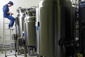 worker inspecting tank