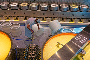 man cleaning container in factory
