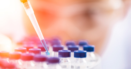 Researcher adding drops to bottles