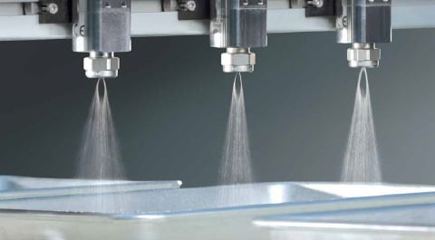 Nozzles spraying in trays