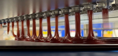 AutoJet DeposiJet system dispensing pizza sauce