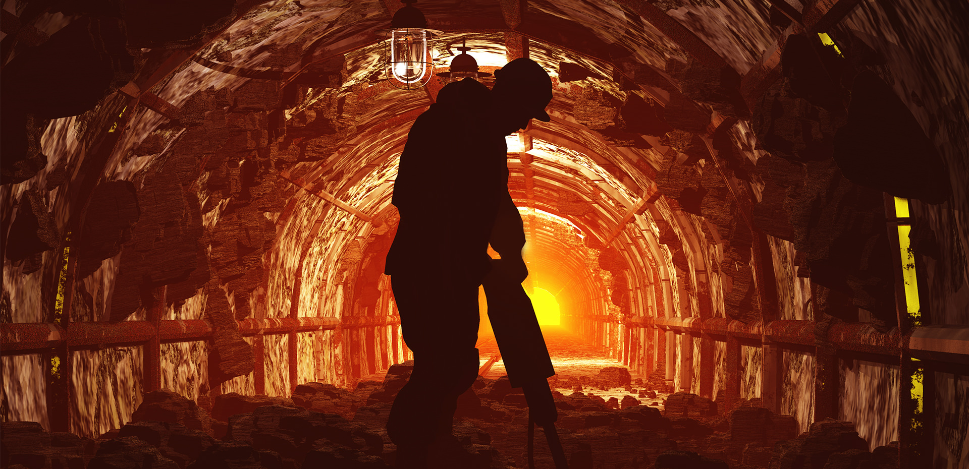 man in sunlit tunnel drilling