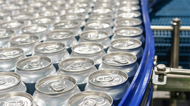 pop cans on conveyor belt