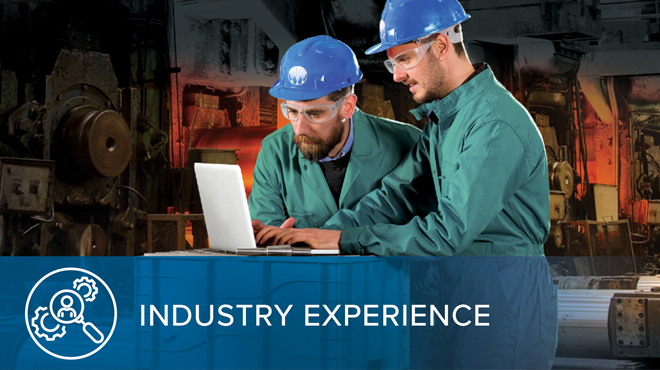 men in hard hats looking at laptop