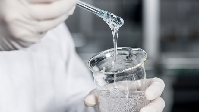 lab person holding test tube with liquid