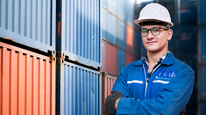 man in hard hat next to storage container