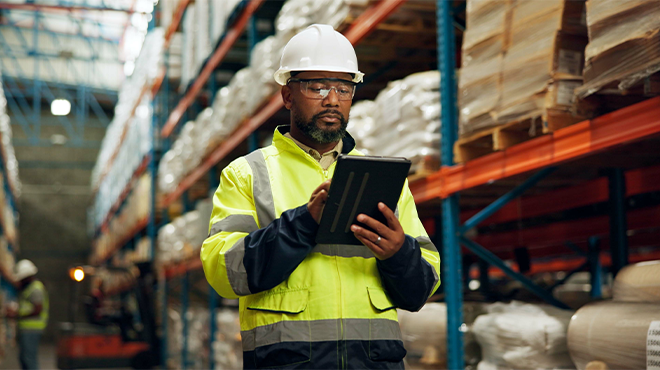man in hard hat on ipad