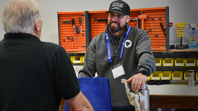 two men talking in a factory
