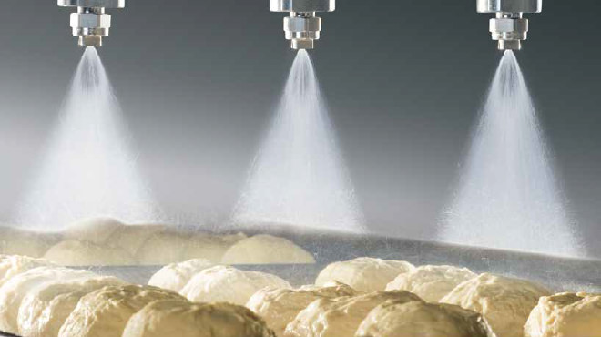 Header spraying on dough