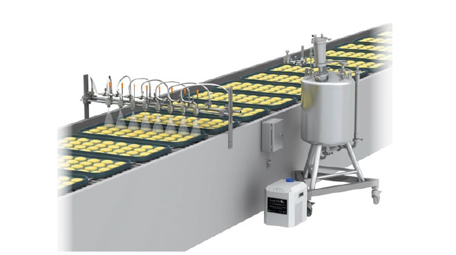 buns on conveyor passing through pulsajet spray nozzles