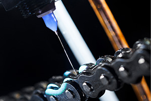 AutoJet electrostatic chain oiler system spraying lubrication onto chain