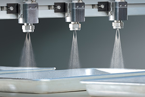 precision spray control used to lubricate pans