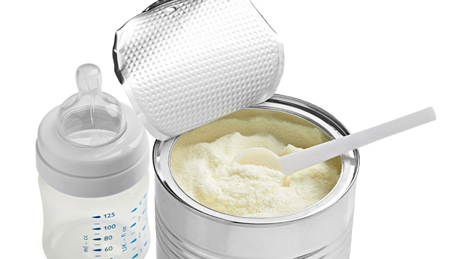 baby formula next to baby bottle