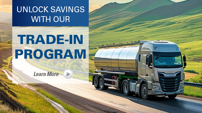 tank truck on road next to grassy hills