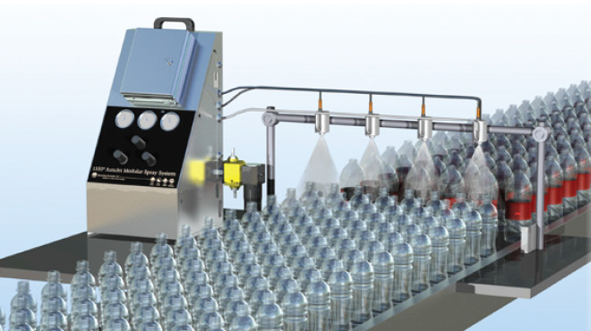lubricant being sprayed on plastic bottles on conveyor