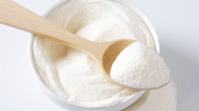 spoonful of milk powder on top of bowl