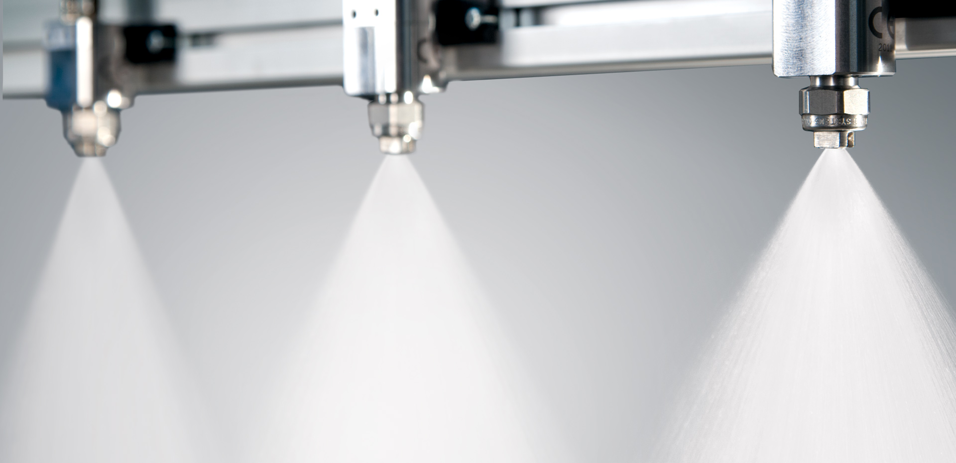 three pulsajet automatic nozzles on header spraying water