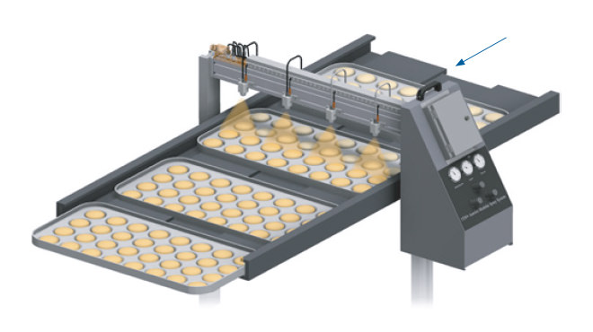 spray nozzles applying egg wash on buns