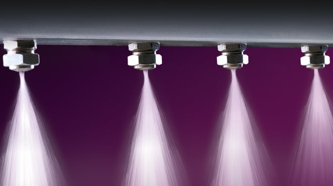 four air atomizing nozzles spraying water