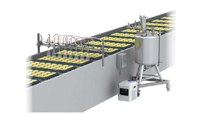 buns on conveyor passing through pulsajet spray nozzles