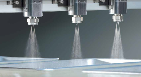 Nozzles spraying in trays