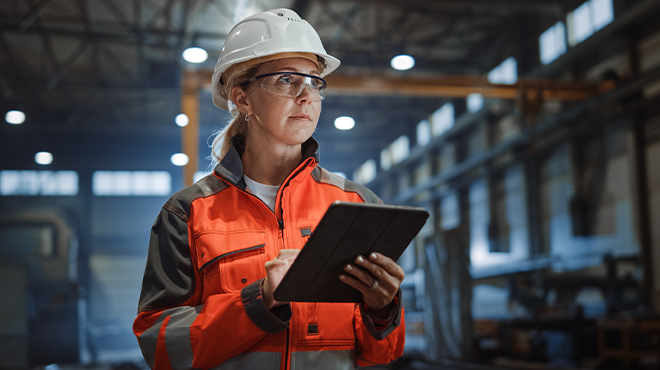 woman in hard hat on ipad