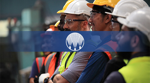 group of men in hard hats with spray logo