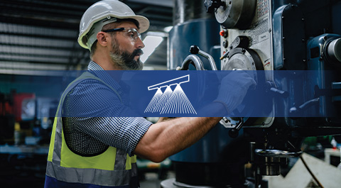 man in hard hat on shop floor with icon overlay
