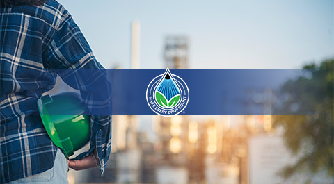 man in hard hat looking at a chemical plant with icon overlay